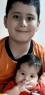 Cute siblings smiling with orange outfits, cheerful vibes.