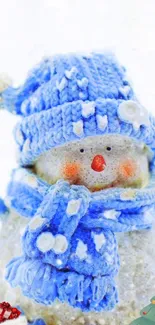 Charming snowman with blue hat and scarf in winter scene.