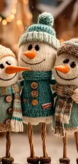 Three adorable snowmen with knitted attire in a winter setting.