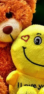Teddy bear and smiley emoji plushies hugging.