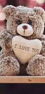 Cute teddy bear holding a heart with 'I Love You' embroidered.