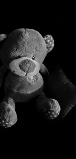 Cute teddy bear on dark background wallpaper.
