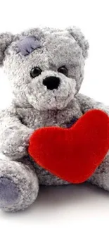 Grey teddy bear with red heart mobile wallpaper.