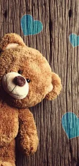 Cute teddy bear with blue hearts wallpaper.