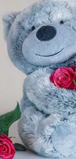 A cute gray teddy bear holding a bouquet of red roses, perfect for mobile wallpaper.