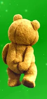 Cute teddy bear on a vibrant green background mobile wallpaper.