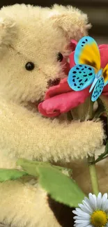 Fuzzy teddy bear holding a pink flower and bright blue butterfly.