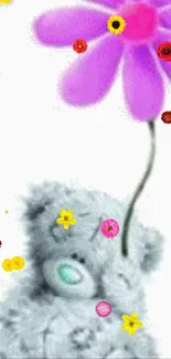 Cute grey teddy bear holding a vibrant purple flower.