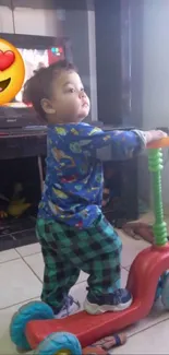 Adorable toddler in colorful outfit rides a toy scooter indoors.