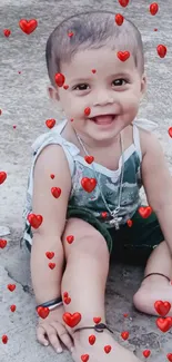 Adorable toddler smiling while sitting on concrete.