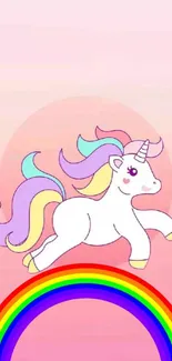 Cute unicorn with rainbow on pastel pink background.