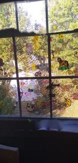 Cute animal stickers on sunlit window view, perfect for a lively mobile wallpaper.