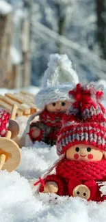 Adorable winter dolls in snow, wearing red knit hats, with wooden sleds.