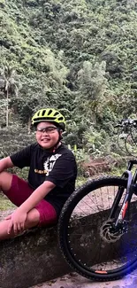 Cyclist smiling beside a bike in lush green scenery.