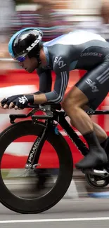 Dynamic cycling race with cyclist in action against red backdrop.