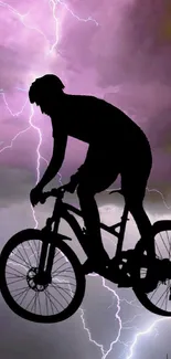 Cyclist silhouette with lightning in pink sky.