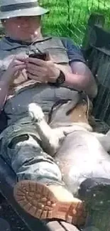 Dad and dog resting on a bench, enjoying a sunny day.