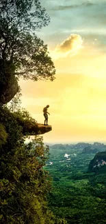 Adventurer on cliff at sunset with lush landscape.