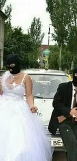 Couple in wedding attire with masks, posing in front of a car in an urban setting.