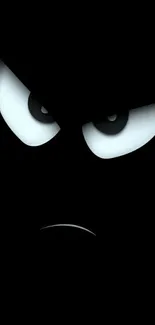 Dark wallpaper featuring an angry face with bright eyes.