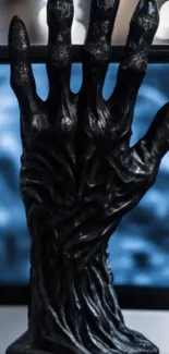 Dark hand sculpture with blue abstract background, artistic phone wallpaper.