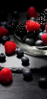 Assorted fresh berries on a dark plate