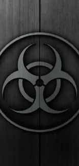 Dark biohazard symbol on black wooden texture wallpaper.