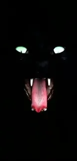 Dark wallpaper with glowing cat eyes and a tongue in the night scene.