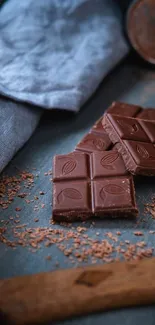 A bar of chocolate on a folded fabric with rustic elements.