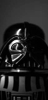 Black and white image of a dark, iconic sci-fi figure with a glowing lightsaber.