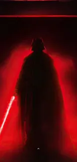 Silhouette with red light saber effect on dark background.