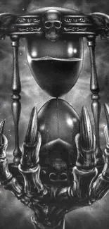 Gothic hourglass with skulls and skeletal hand, in monochrome black.