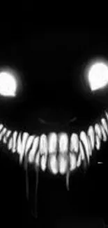 Eerie black wallpaper with a grinning monster face.