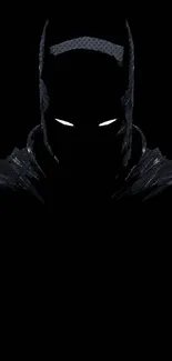 Dark silhouette of a superhero with glowing eyes on a black background.