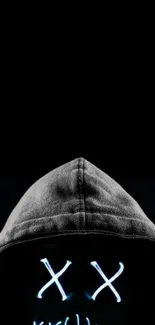 Hooded figure with glowing eyes on a black background.