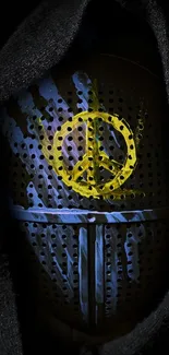 Dark hooded figure with peace symbol mask on black background.