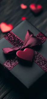 Dark gift box with red hearts and ribbon.