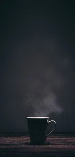 Dark moody wallpaper with steaming coffee cup on wooden table.