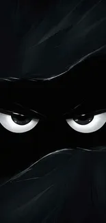 Dark wallpaper with mysterious eyes in shadow.