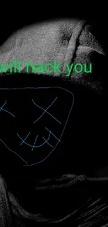 Dark hooded figure with hacker smiley face on a black background.