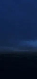 Moody ocean at night with dark clouds overhead, creating a serene ambiance.