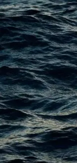 Dark ocean waves creating a moody, aesthetic wallpaper for mobile devices.