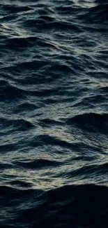 Dark blue ocean waves on mobile wallpaper.