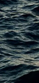 Dark ocean waves creating a serene and textured wallpaper for mobile screens.