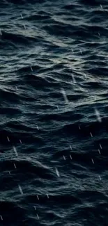 Dark ocean waves with raindrops falling on the water surface.