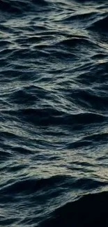 Dark ocean waves creating a calm and serene mobile wallpaper.