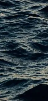 Dark ocean waves creating a textured, serene mobile wallpaper.