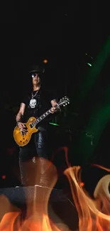 Guitarist playing on a dark stage with vibrant green lights.