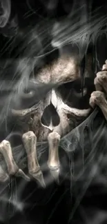 Eerie dark skull with bony hands mobile wallpaper.