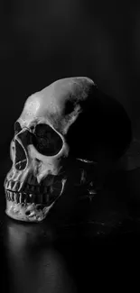 Black skull on dark background mobile wallpaper.